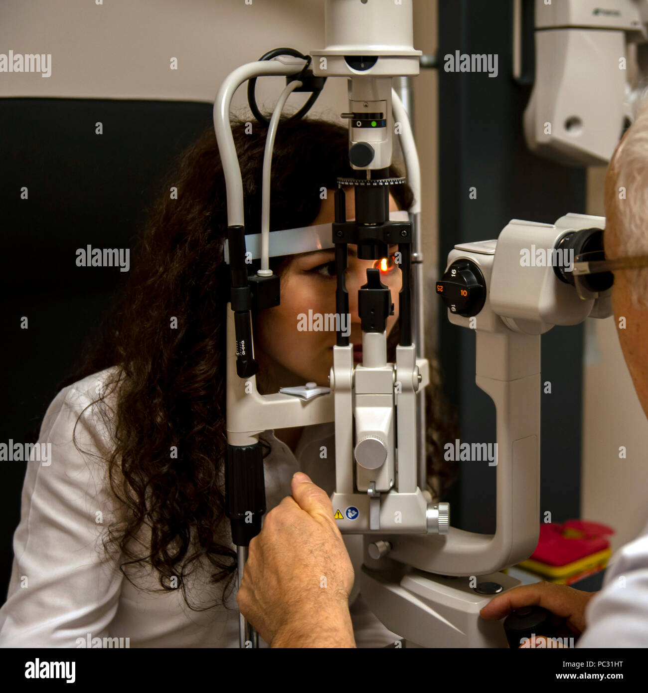 An eye doctor examining the eye disease. It is necessary to decide whether or not to wear glasses. Stock Photo