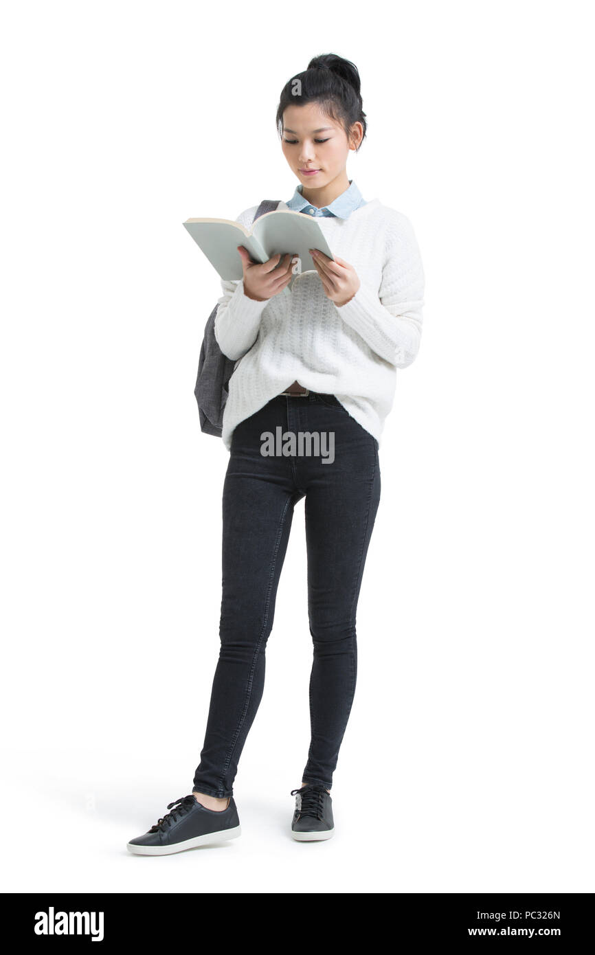 Cheerful female college student reading a book Stock Photo