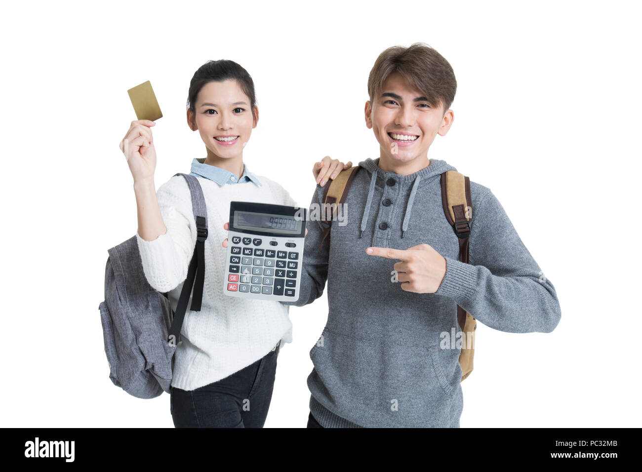 Cheerful college students holding calculator and credit card Stock