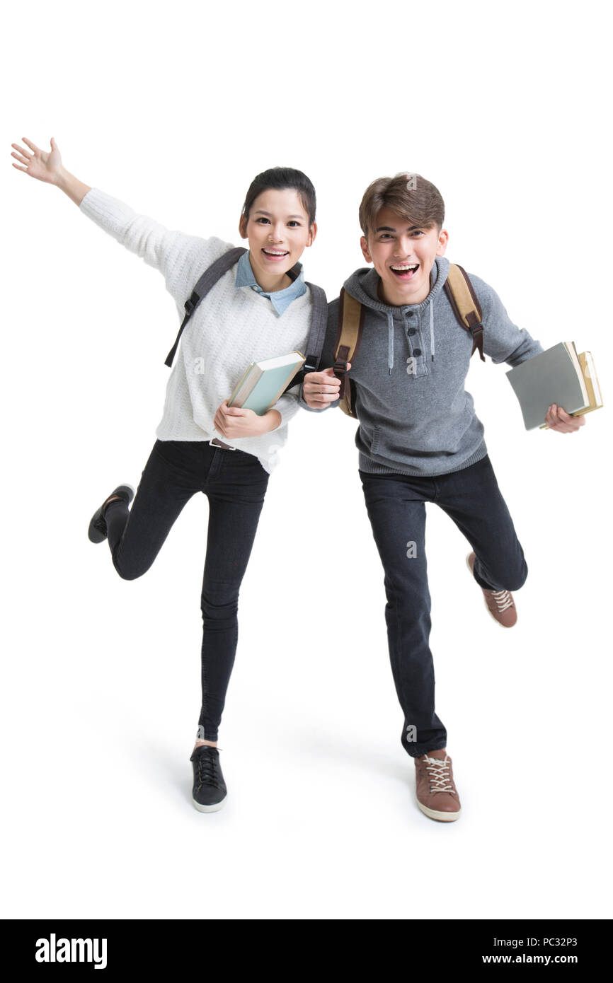 Cheerful college students holding books Stock Photo - Alamy