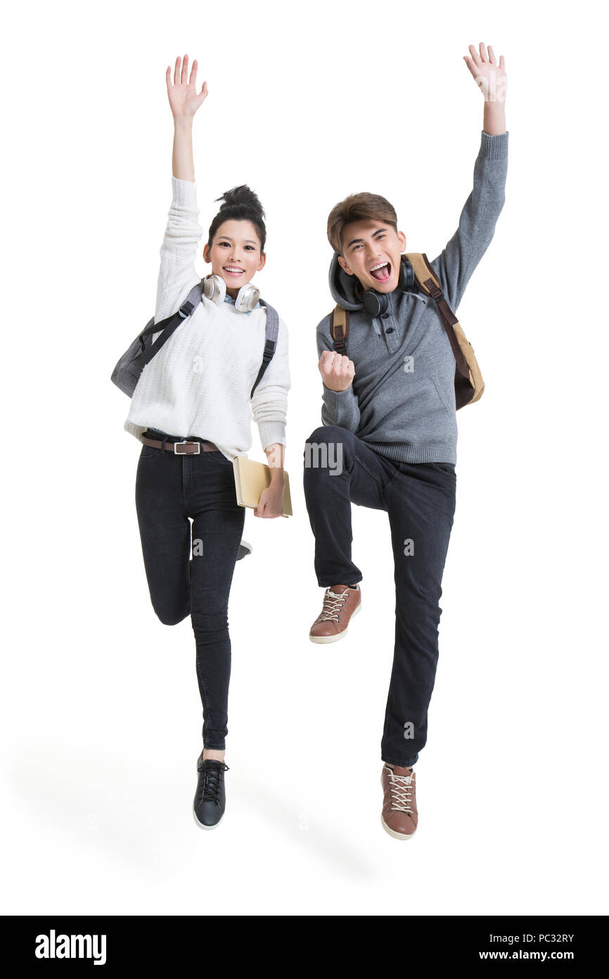 Cheerful college students jumping Stock Photo
