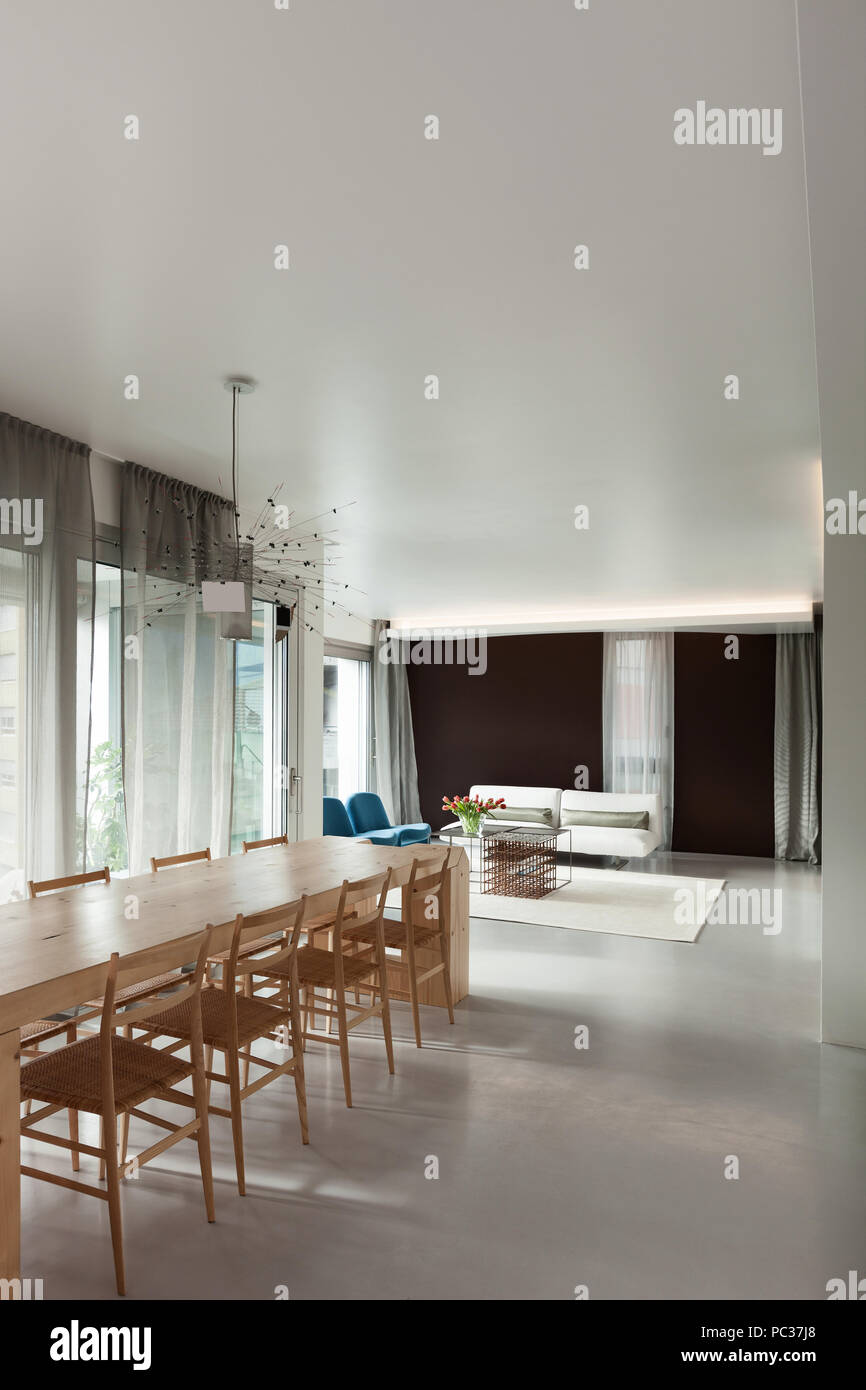 Luxury apartment, wooden dining table in modern open space Stock Photo ...