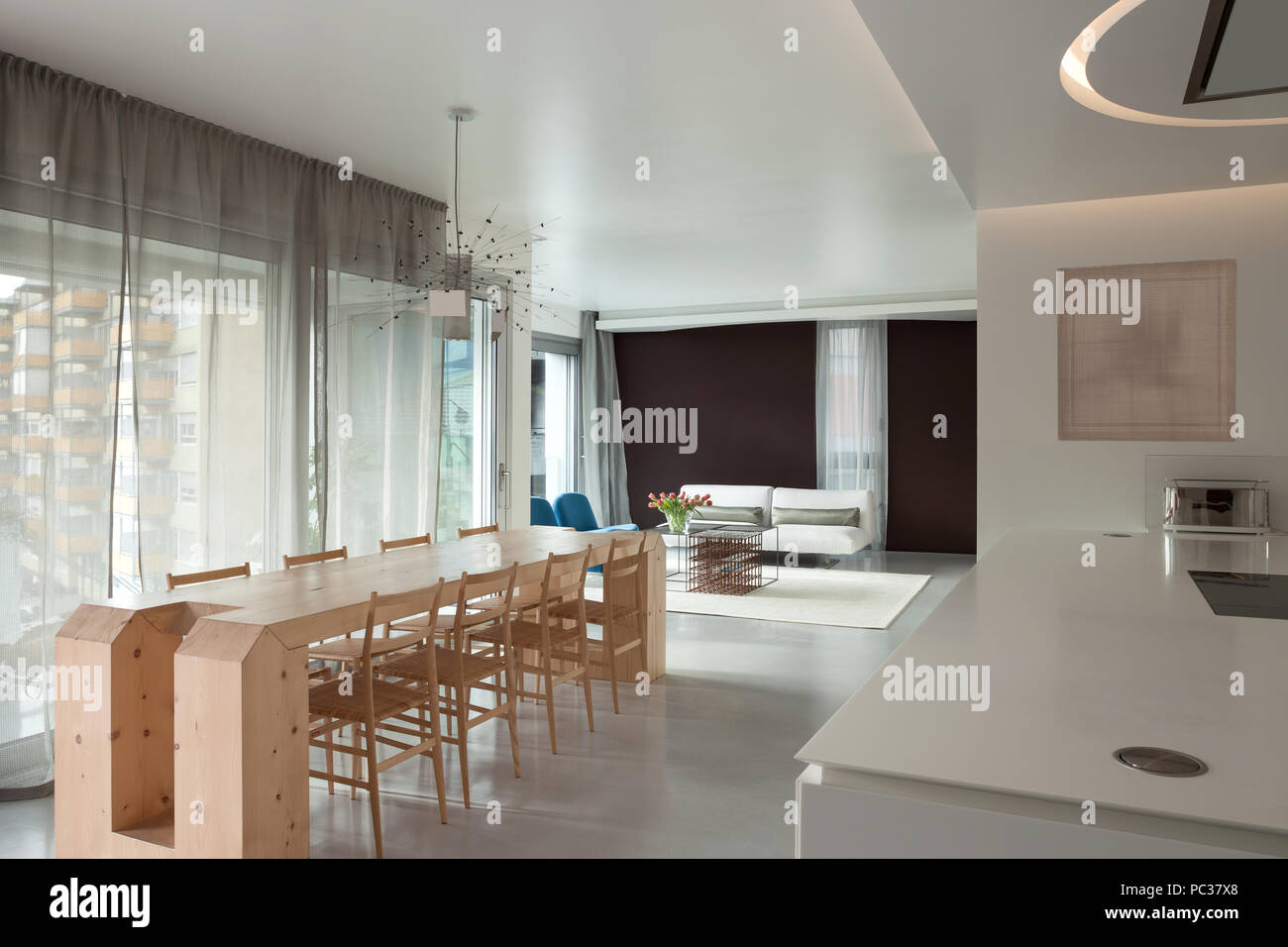 Luxury apartment, wooden dining table and modern kitchen Stock Photo ... - Wood Dining Creations At Rent Apartments