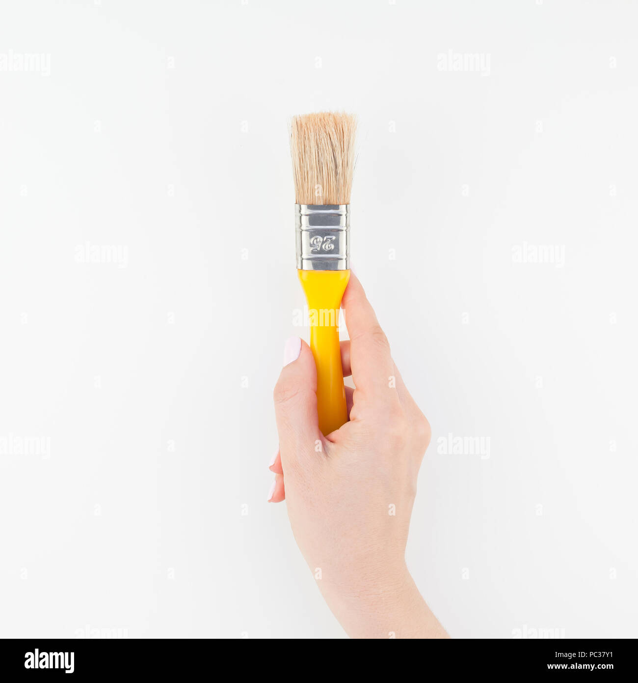 Square image of woman hand holding new paint brush with copy space ...
