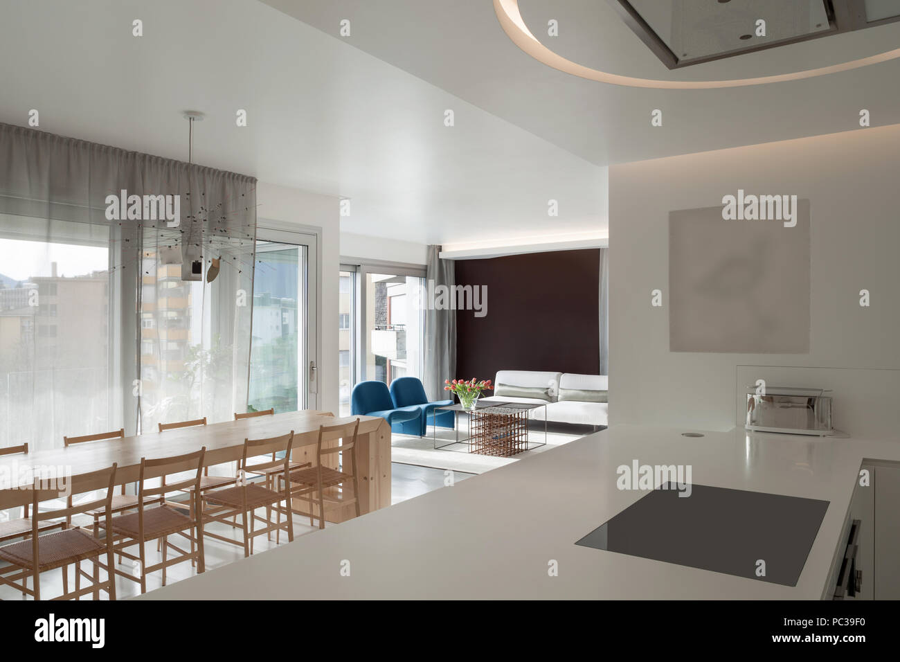 Luxury apartment, modern kitchen and wooden dining table Stock Photo
