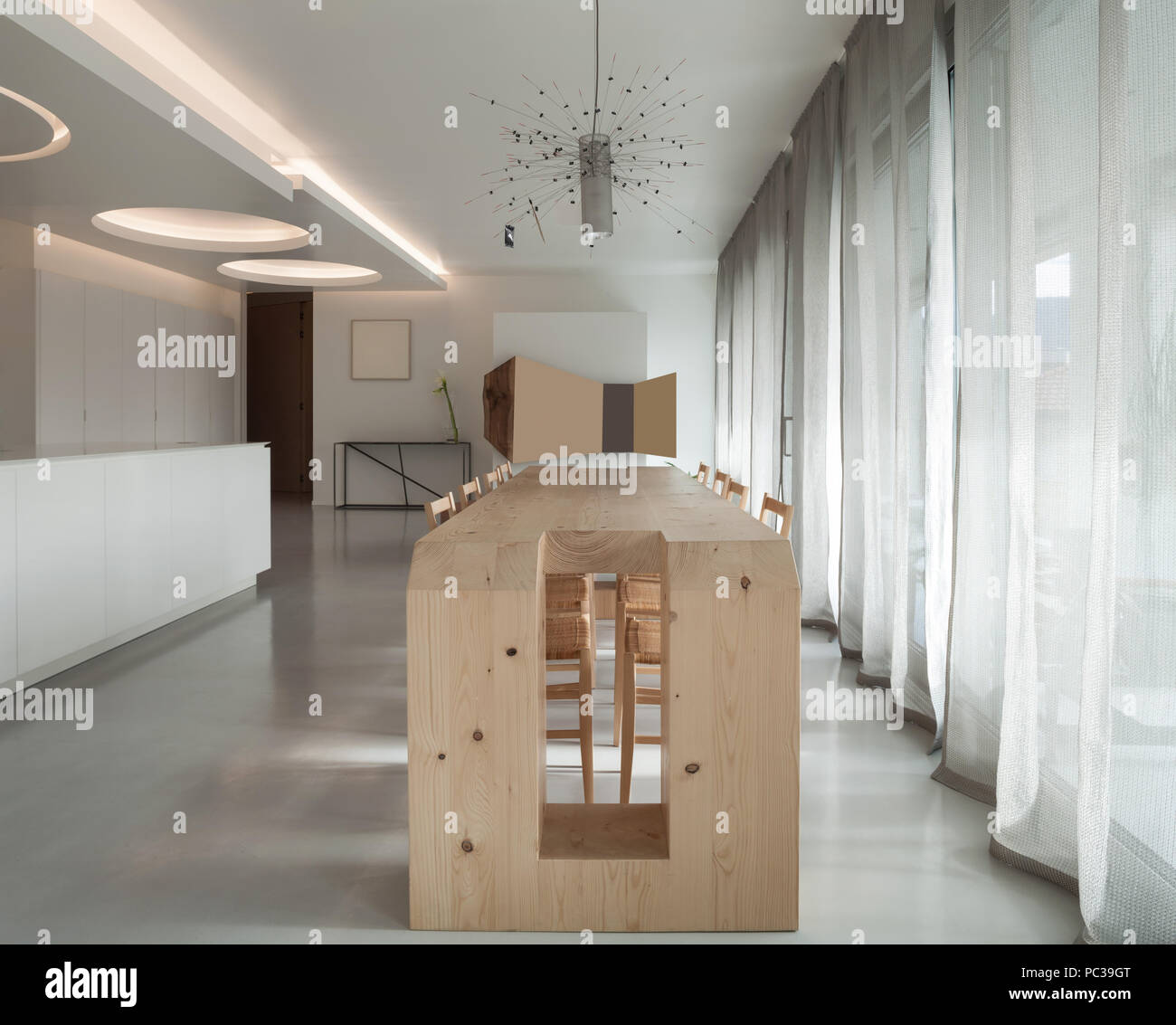 View of Luxury apartment, wooden dining table and modern kitchen Stock Photo ...