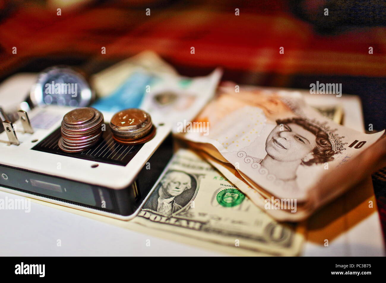 Time, money, energy concept shot on plaid blanket with battery, wrist ...