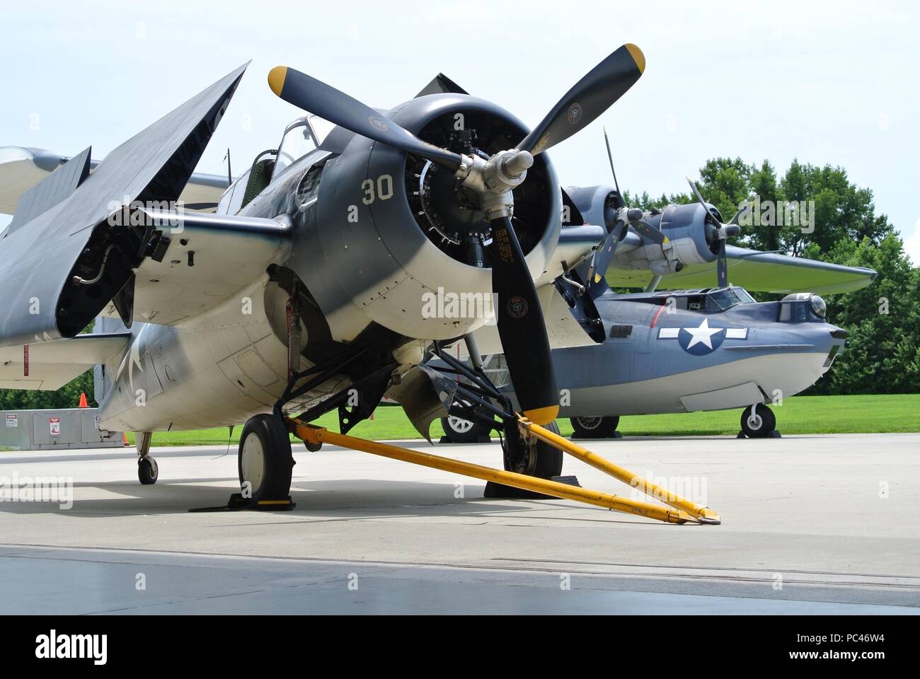 A Grumman FM-2 Wildcat (foreground) and a Consolidated Catalina PBY-5A (rear) on display at the Military Aviation Museum in Virginia Beach, Virginia. (US Navy Photo by Civilian Public Affairs Officer Max Lonzanida/Released) Stock Photo