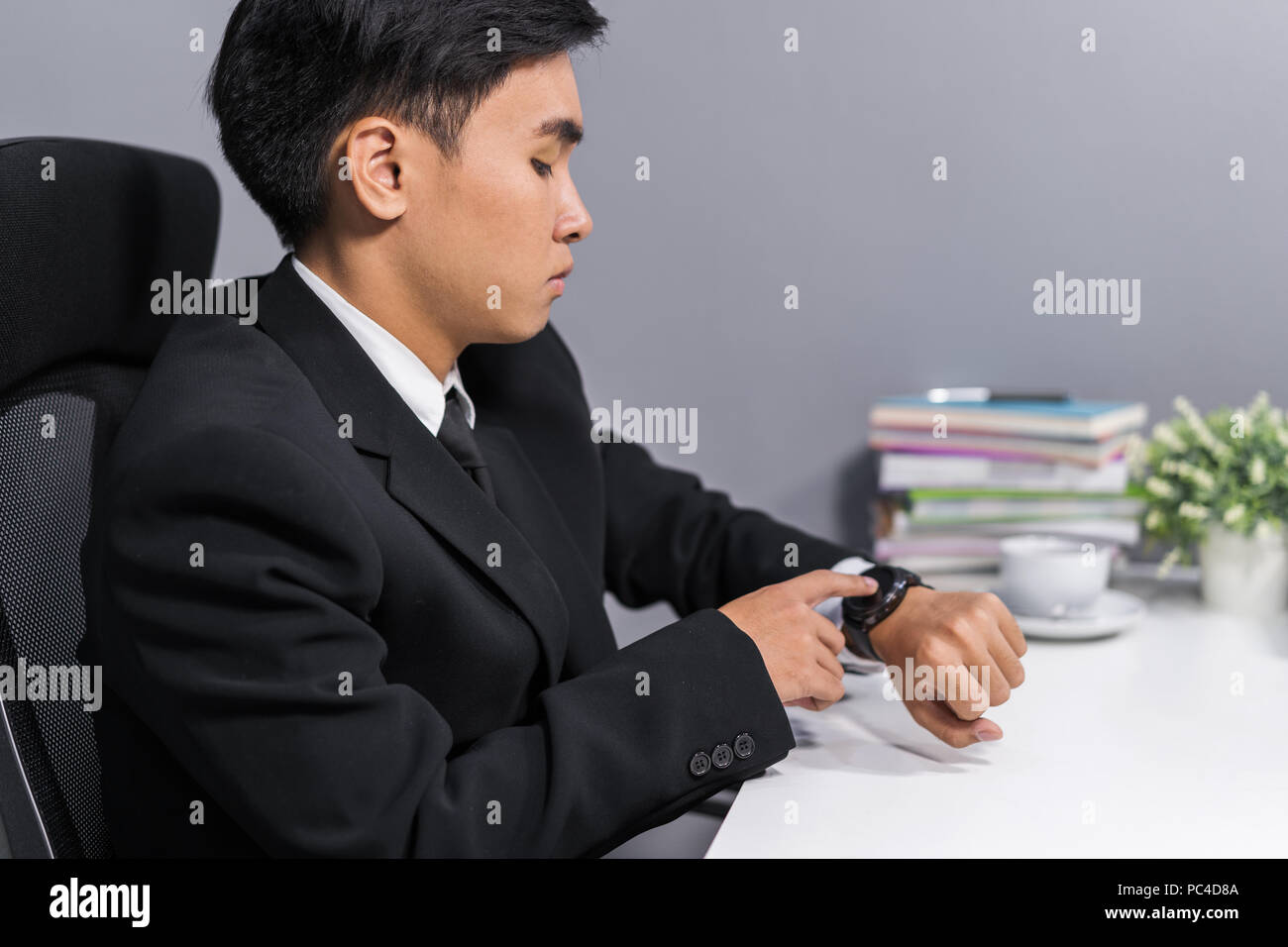 young business man checking time on smart watch Stock Photo - Alamy