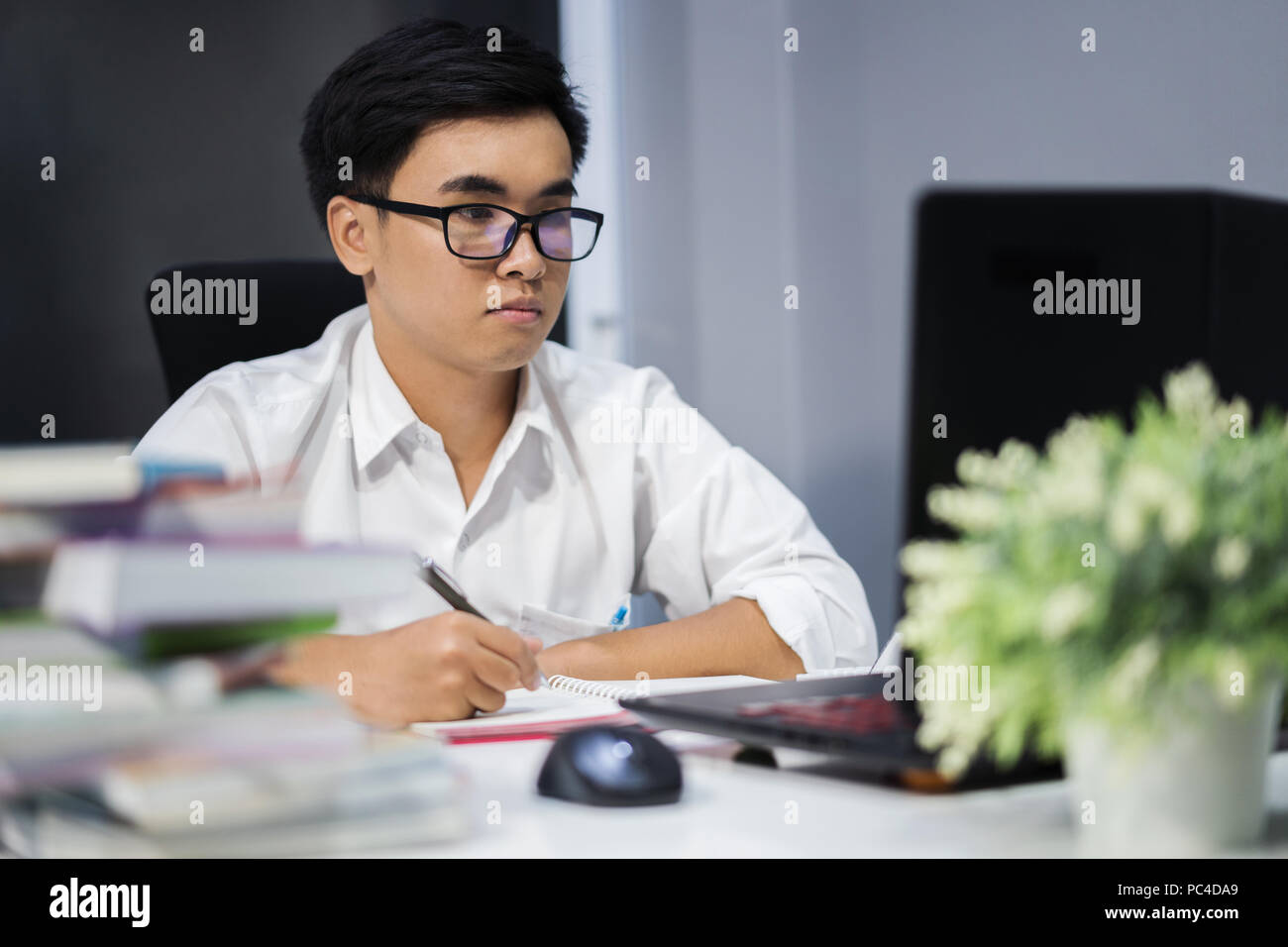 Asian college male writing hires stock photography and images Alamy