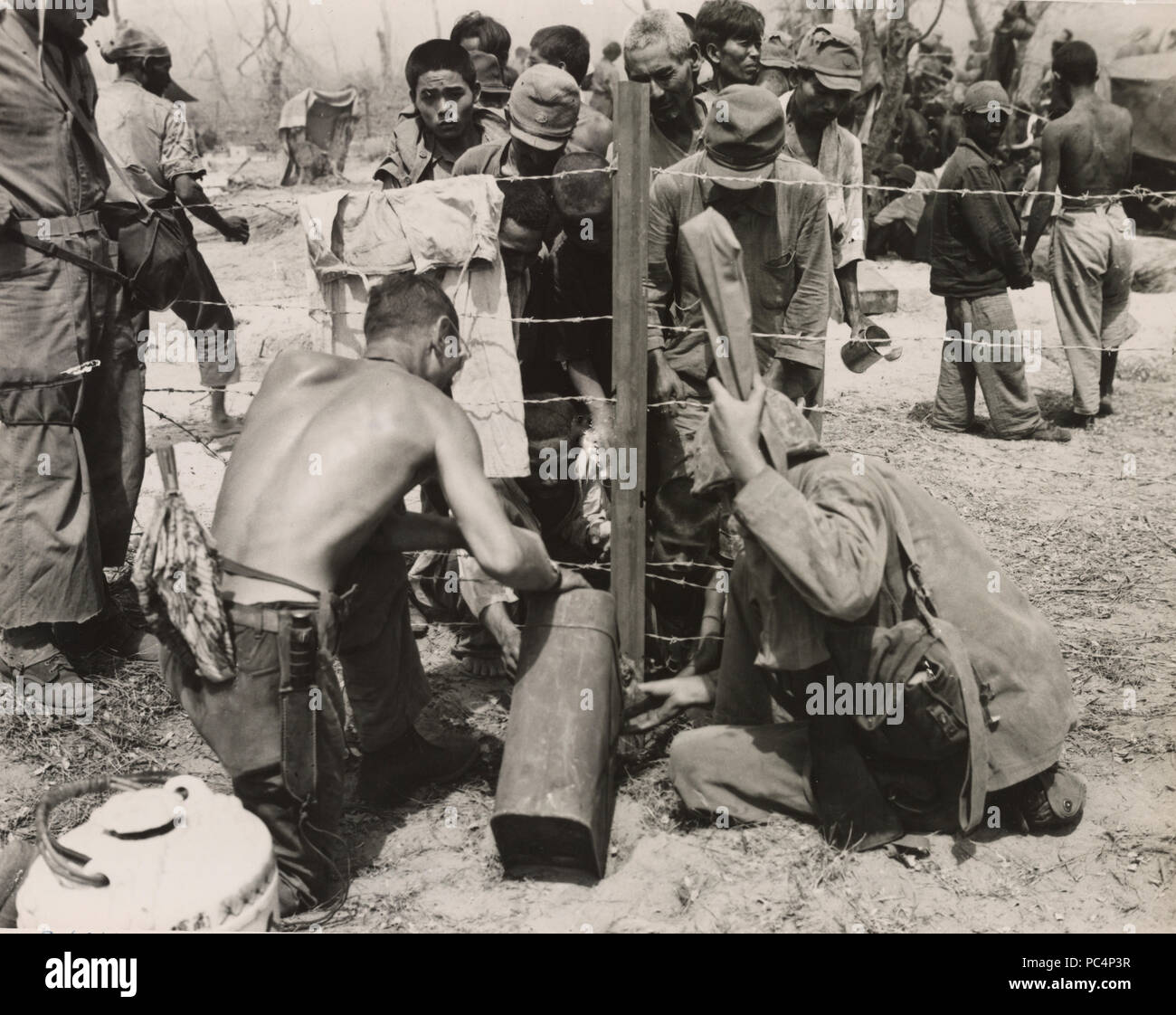 Maines give water to civilian prisoners on Saipan Stock Photo Alamy