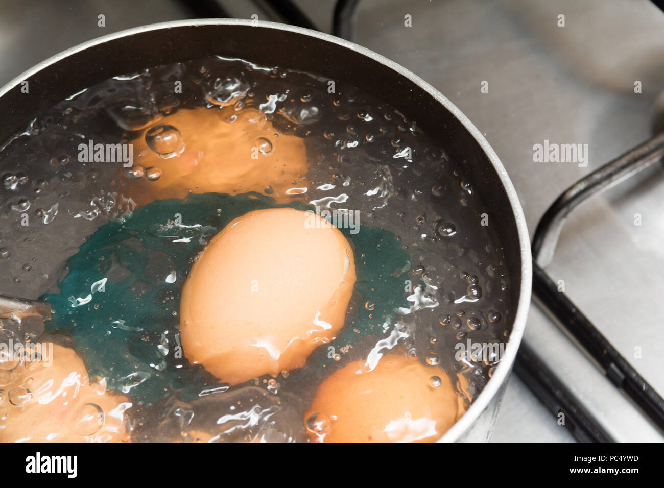 Cooking boiled eggs in a pan of boiling water Stock Photo - Alamy