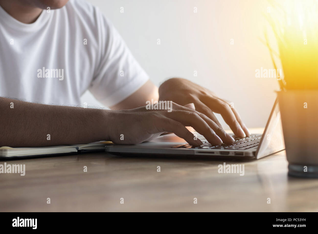 Man pressing and using computer for searching and finding new information and idea in library Stock Photo