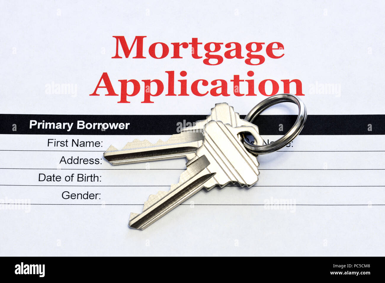 Real Estate Mortgage Application Loan Document With House Keys Stock Photo