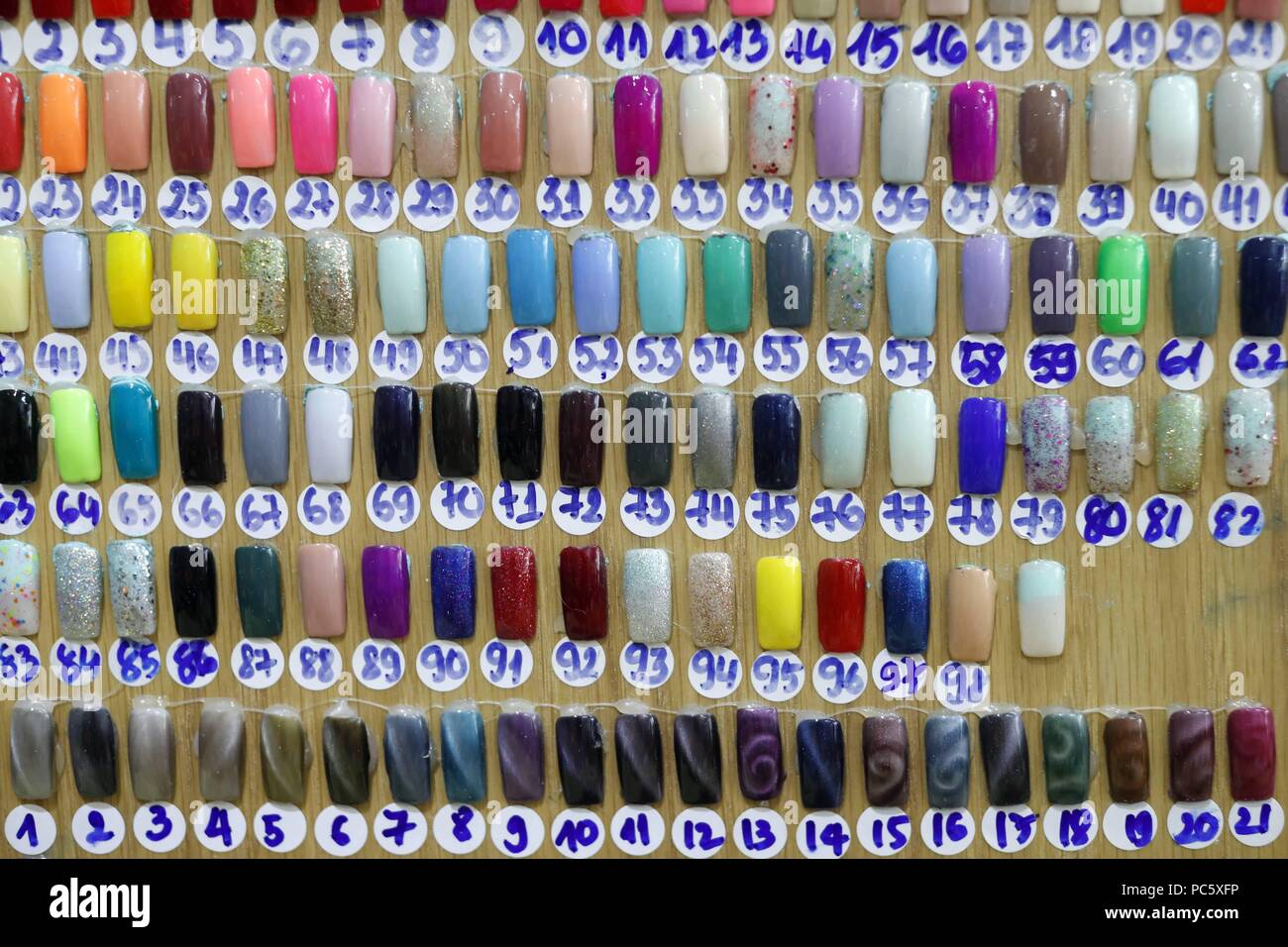 Artificial acrylic nails painted on display in nail salon. Ho Chi Minh ...