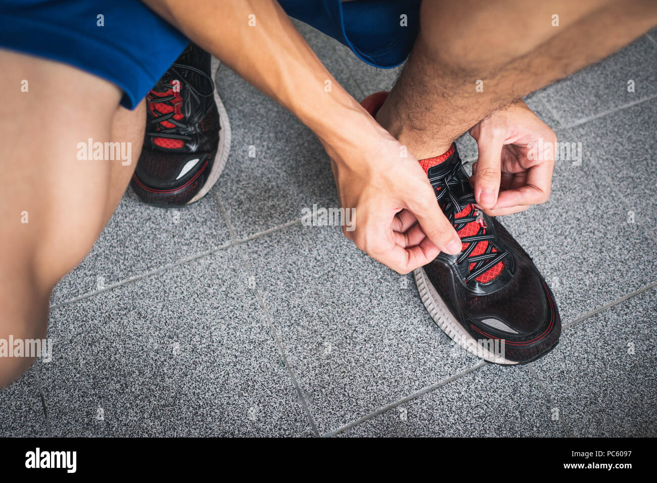 Men lacing up running shoes Stock Photo Alamy