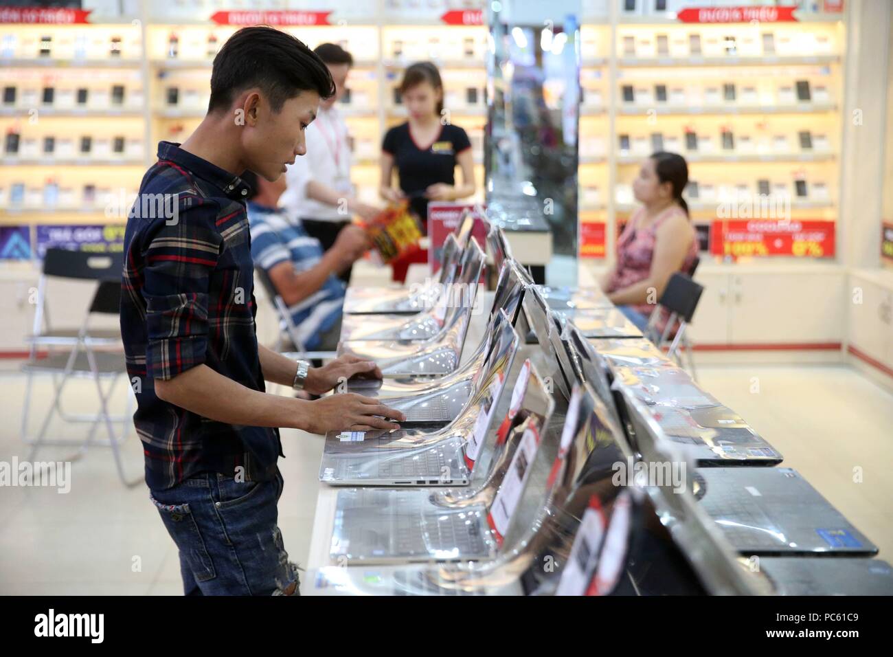 Computer shop. Young student baying a laptop. Thay Ninh. Vietnam ...