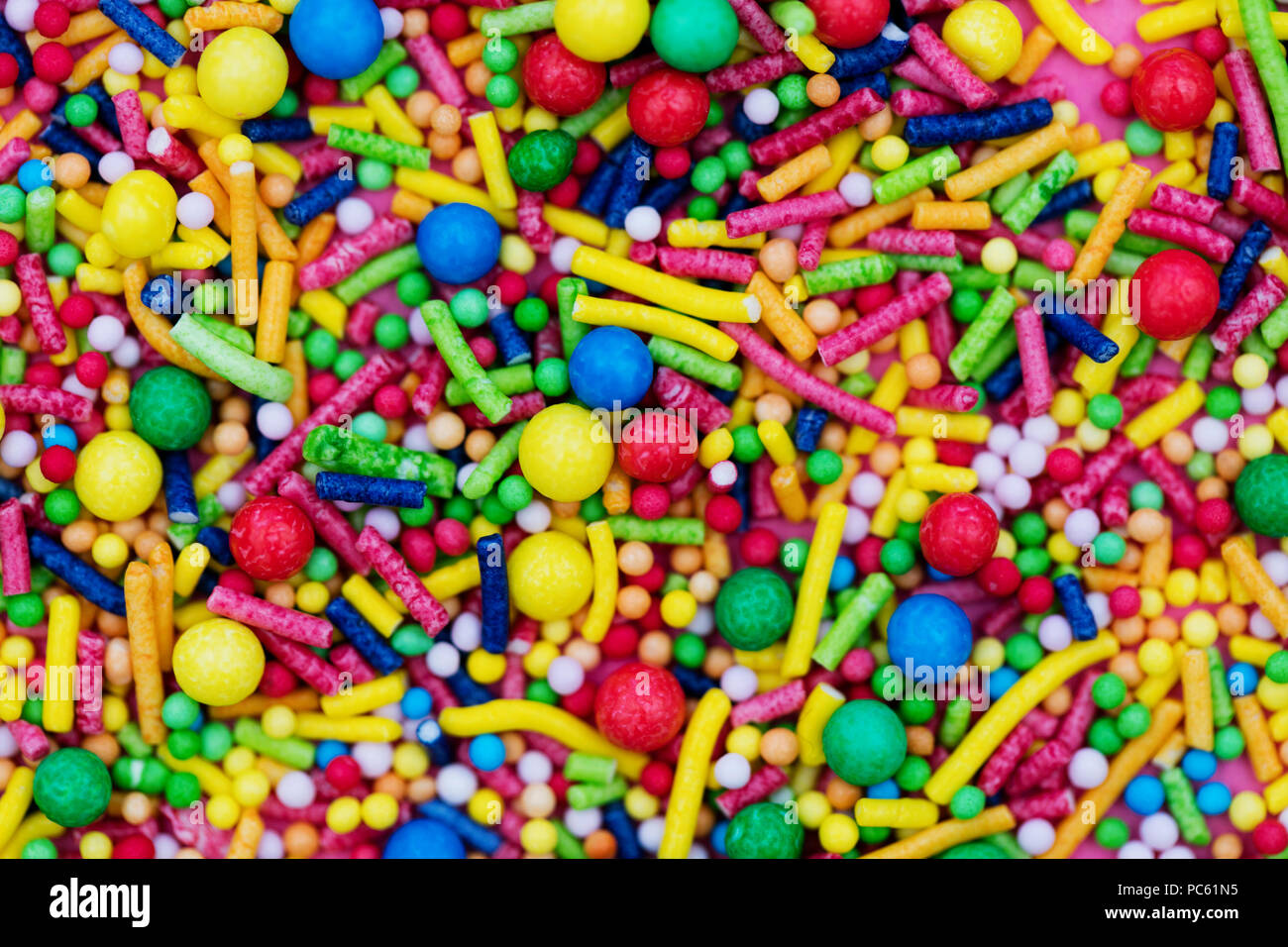 Colourful candy cake decorative sprinkles background Stock Photo