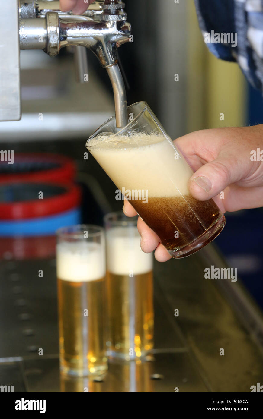 ILLUSTRATION - A glass of Altbier 'old beer', a dark top-fermented beer  traditionally brewed around the city of Düsseldorf, is poured from a tap in  a pub in Moers, Germany, 21 February.