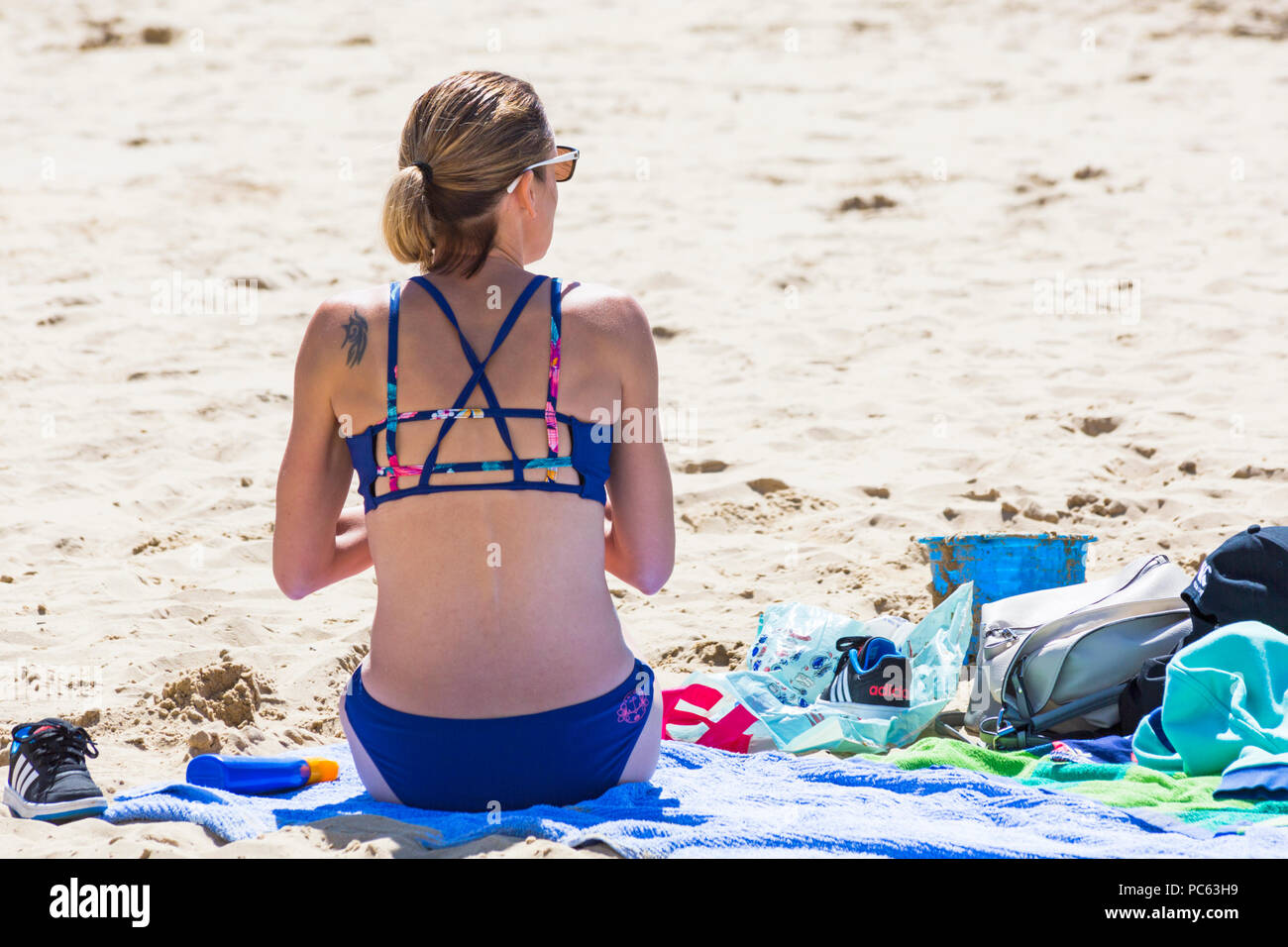 Bournemouth, Dorset, UK. 31st July 2018. UK weather:  the sun returns and temperatures rise as beach-goers head to the seaside to enjoy the warm sunny weather. woman in bikini sunbathing on beach. Credit: Carolyn Jenkins/Alamy Live News Stock Photo