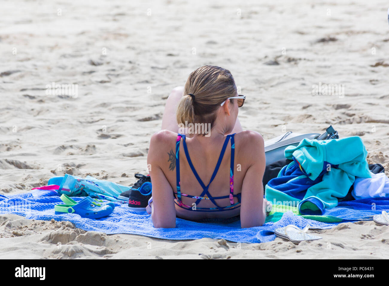 Bournemouth, Dorset, UK. 31st July 2018. UK weather:  the sun returns and temperatures rise as beach-goers head to the seaside to enjoy the warm sunny weather. woman sunbathing on beach. Credit: Carolyn Jenkins/Alamy Live News Stock Photo