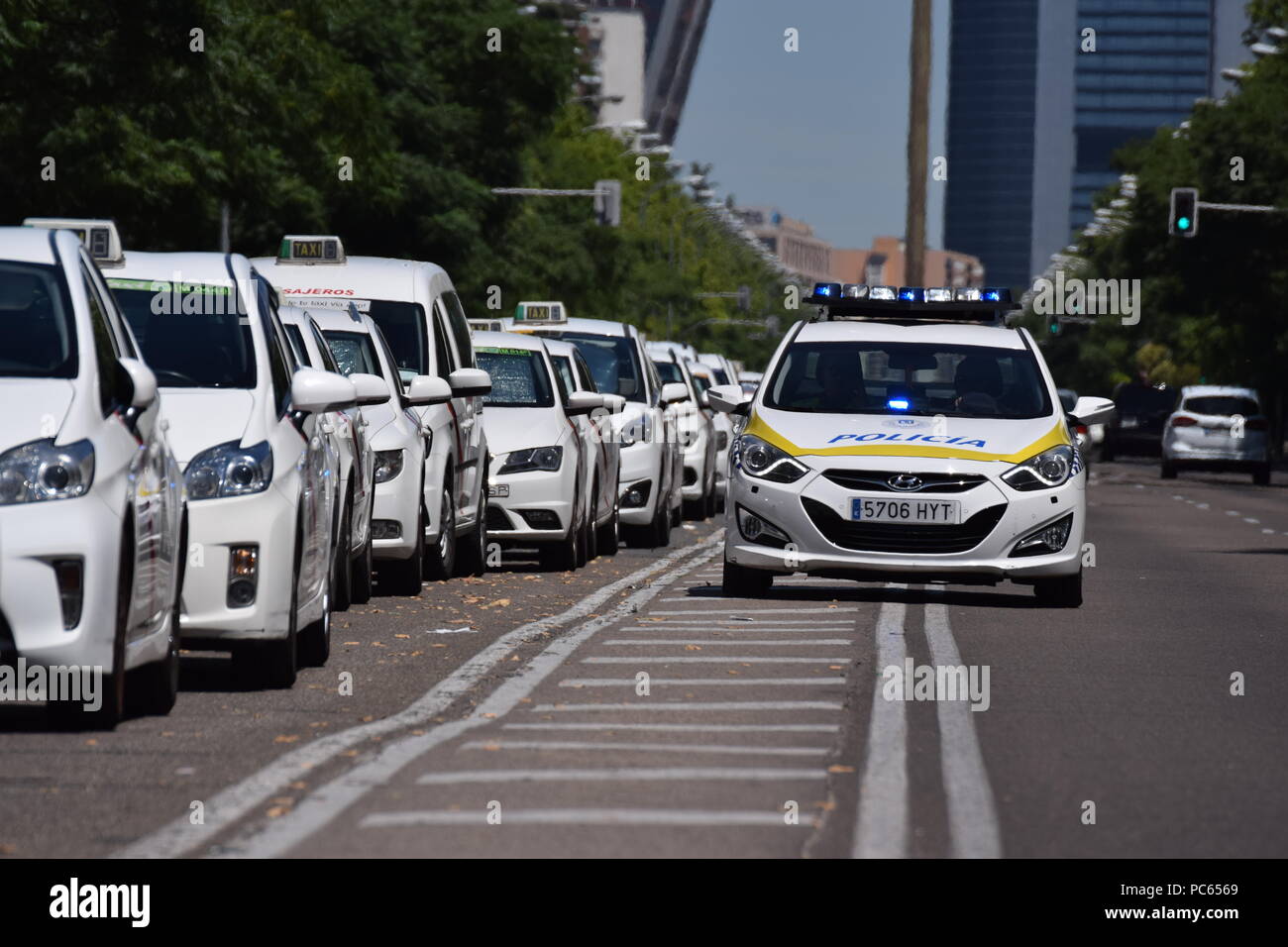 Madrid, Spain.  Taxis block an avenue amid a strike by cabbies in Madrid on July 31, 2018.    Taxi drivers across Spain kept striking against ride-hailing competitors such as Uber and Cabify, which they say unfairly threaten their livelihoods after government negotiations ended without a deal. The strike began in Barcelona last week and spread to Madrid at the weekend as drivers blocked main thoroughfares, demanding action from the government.  Sierra/797/Cordon Press Stock Photo