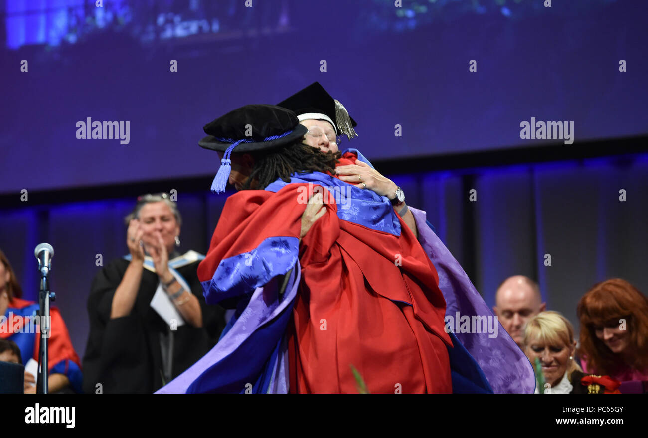 Brighton UK 31st July 2018 - The renowned rapper and writer Akala receives a Doctor of Arts in recognition of his major contribution to empowering young people through learning at the University of Brighton Graduation ceremony today . The award was presented by Professor Debra Humphris the Vice-Chancellor of the University of Brighton Credit: Simon Dack/Alamy Live News Stock Photo