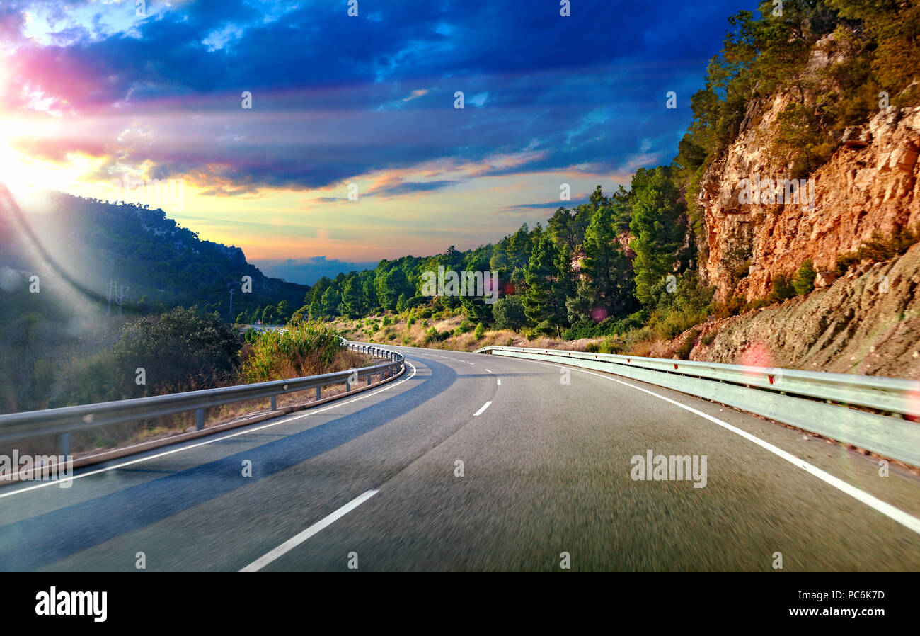 Road and travel concept.Sunset landscape and mountains.Highway to destiny.Tranquility and safety driving Stock Photo