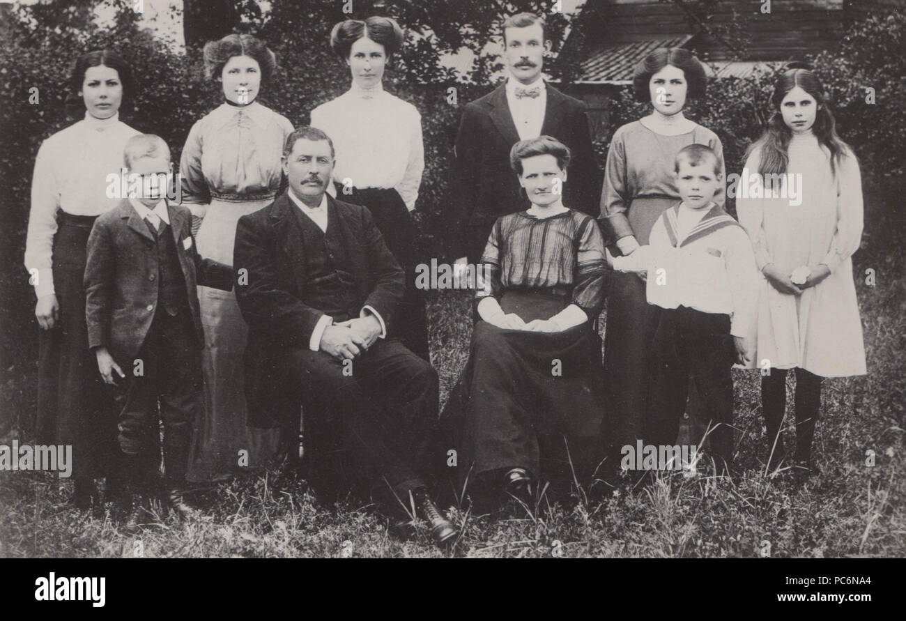Vintage Photograph of a Large Family Group Posing In Their Garden. Stock Photo