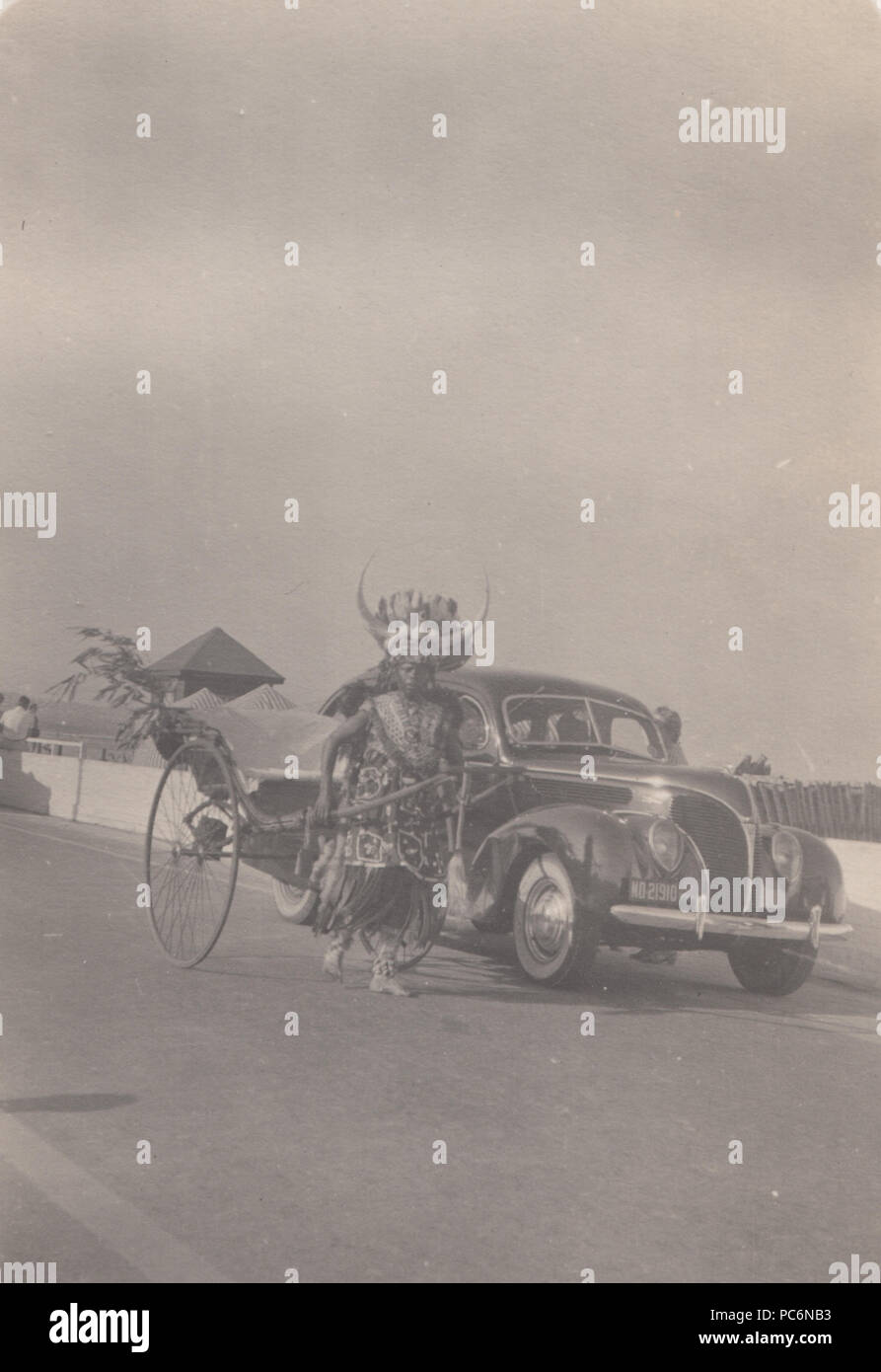 Vintage 1939 Photograph of a Pulled Rickshaw and Classic Car in Durban, South Africa Stock Photo