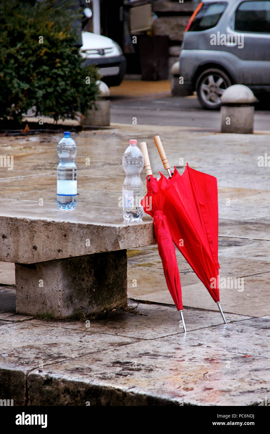 Two red umbrellas on rainy street left Stock Photo