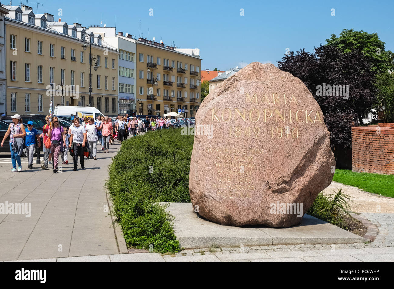 Warsaw, Poland - July 19, 2018: Grave stone to Maria Konotopnicka and group of people in an old town of Warsaw, Poland. Stock Photo