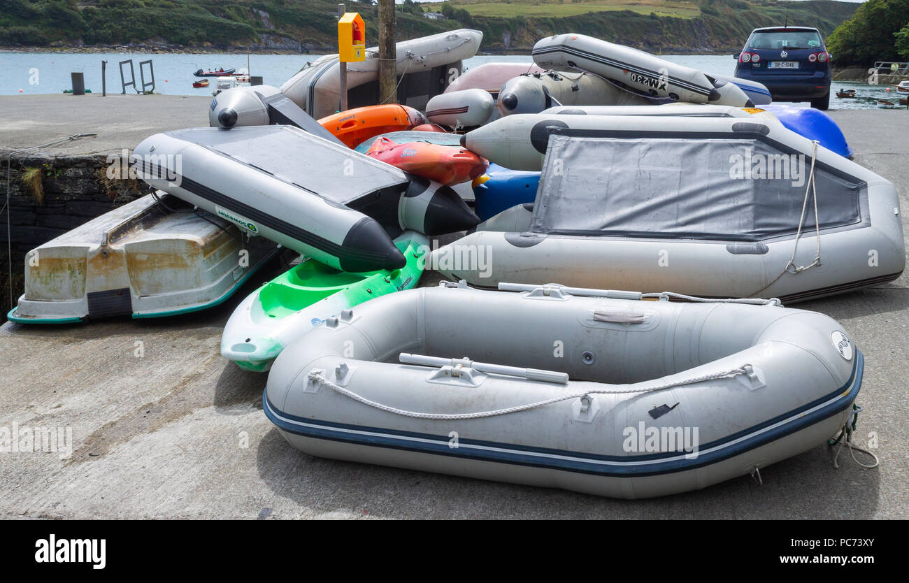 pile of rubber dinghy's on a quayside in west cork, ireland Stock Photo