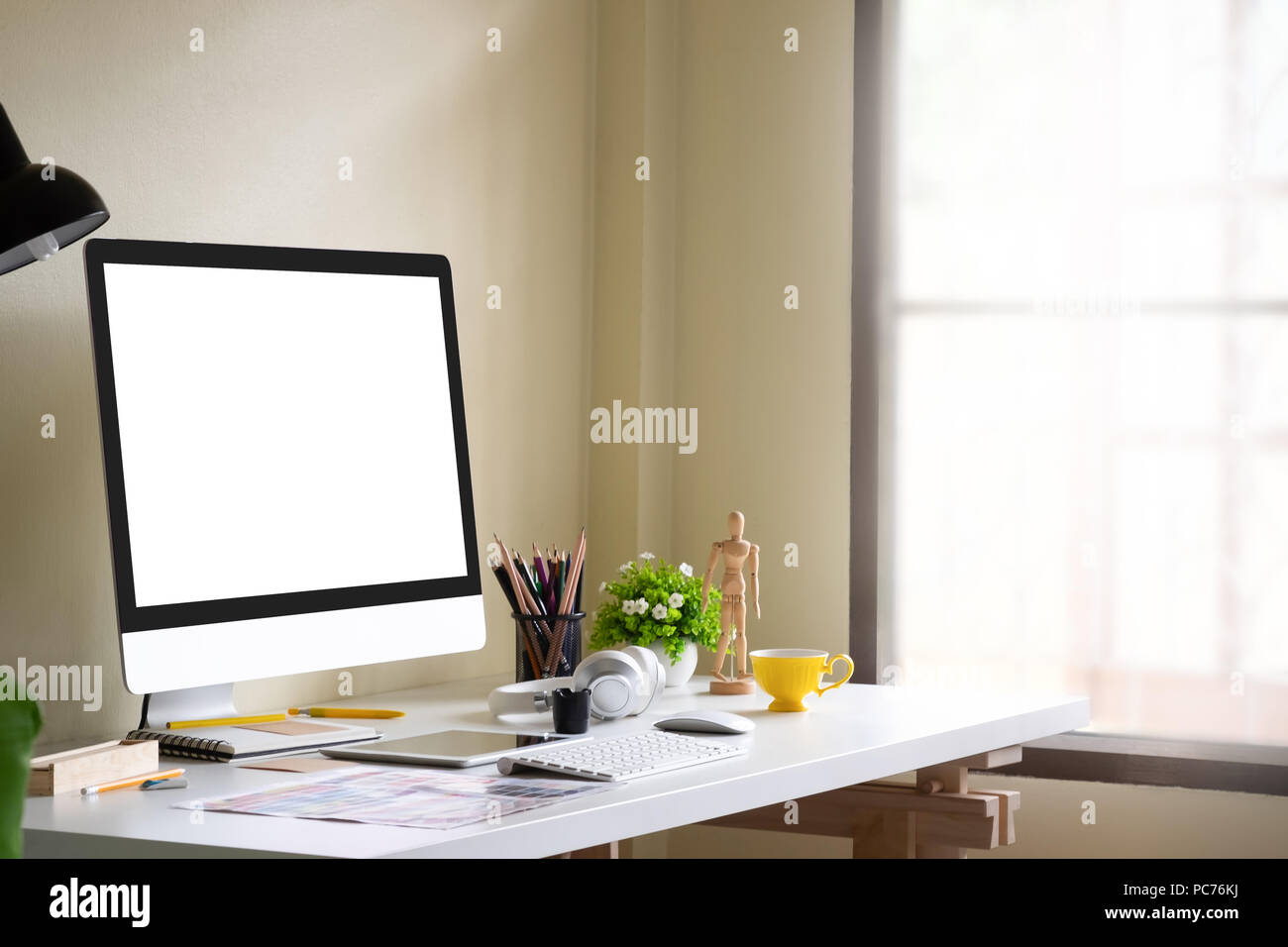 Side view mockup computer on office workplace Stock Photo - Alamy