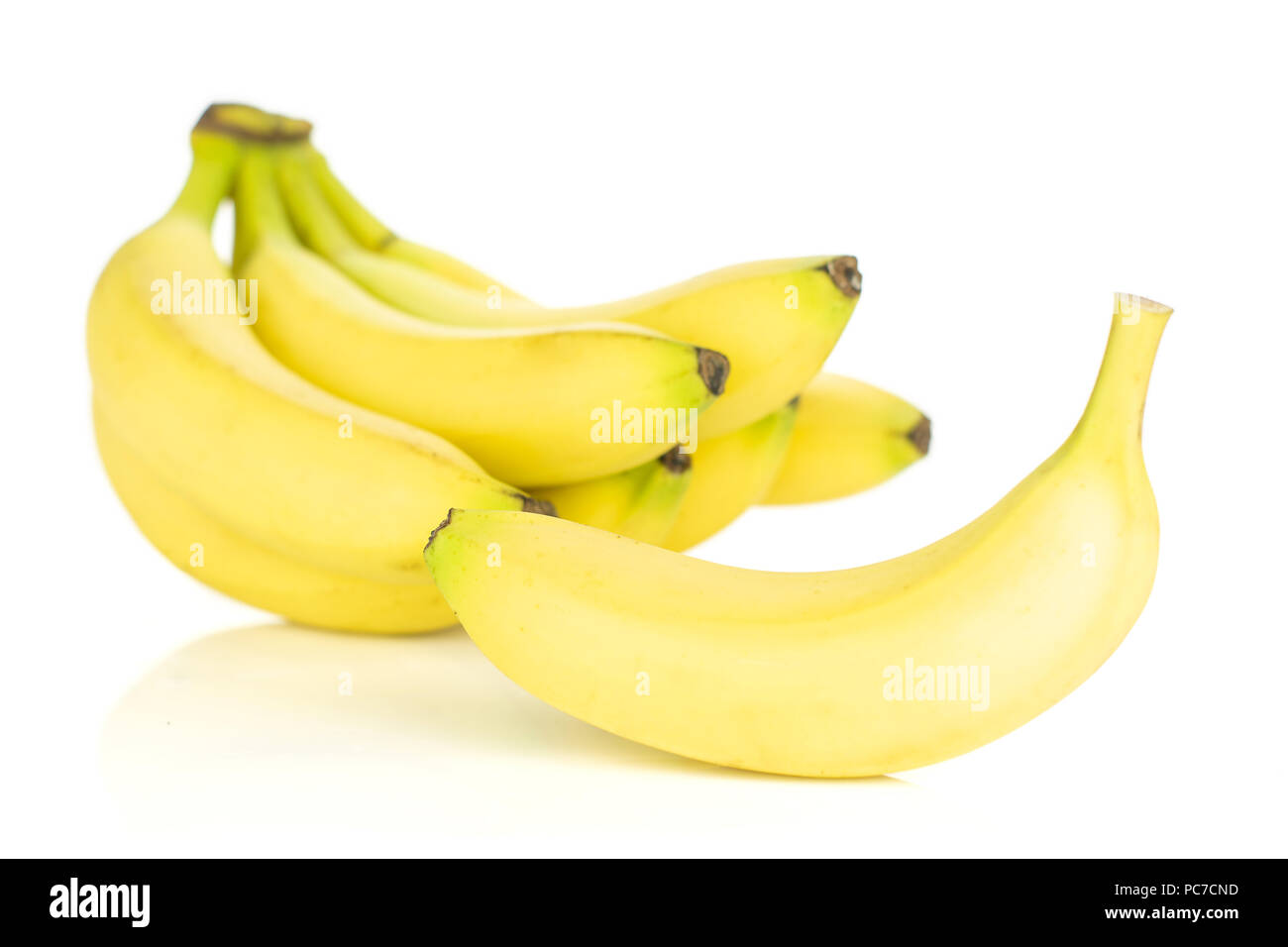 Lot of whole fresh yellow banana one cluster and separated banana isolated on white background Stock Photo