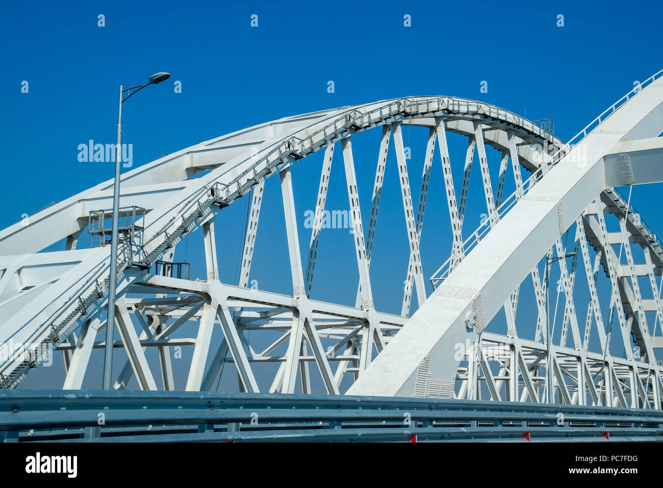 The navigable arch of the Crimean bridge. Arch of the highway and railway section of the Crimean bridge. Driving along the Crimean bridge. A grandiose Stock Photo