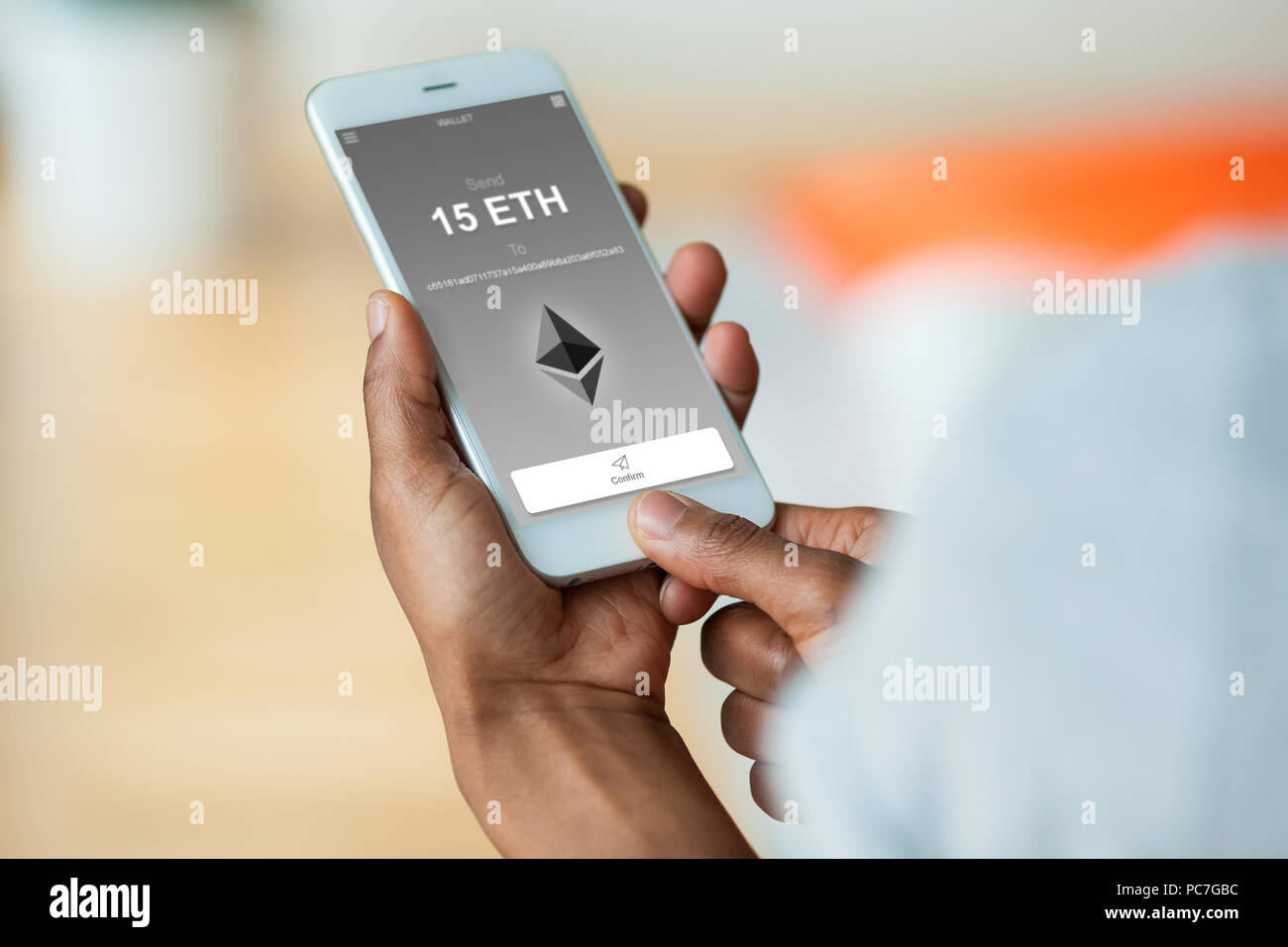 African american person sending a ethereum eth crypto transaction using  mobile phone wallet - Black people Stock Photo - Alamy