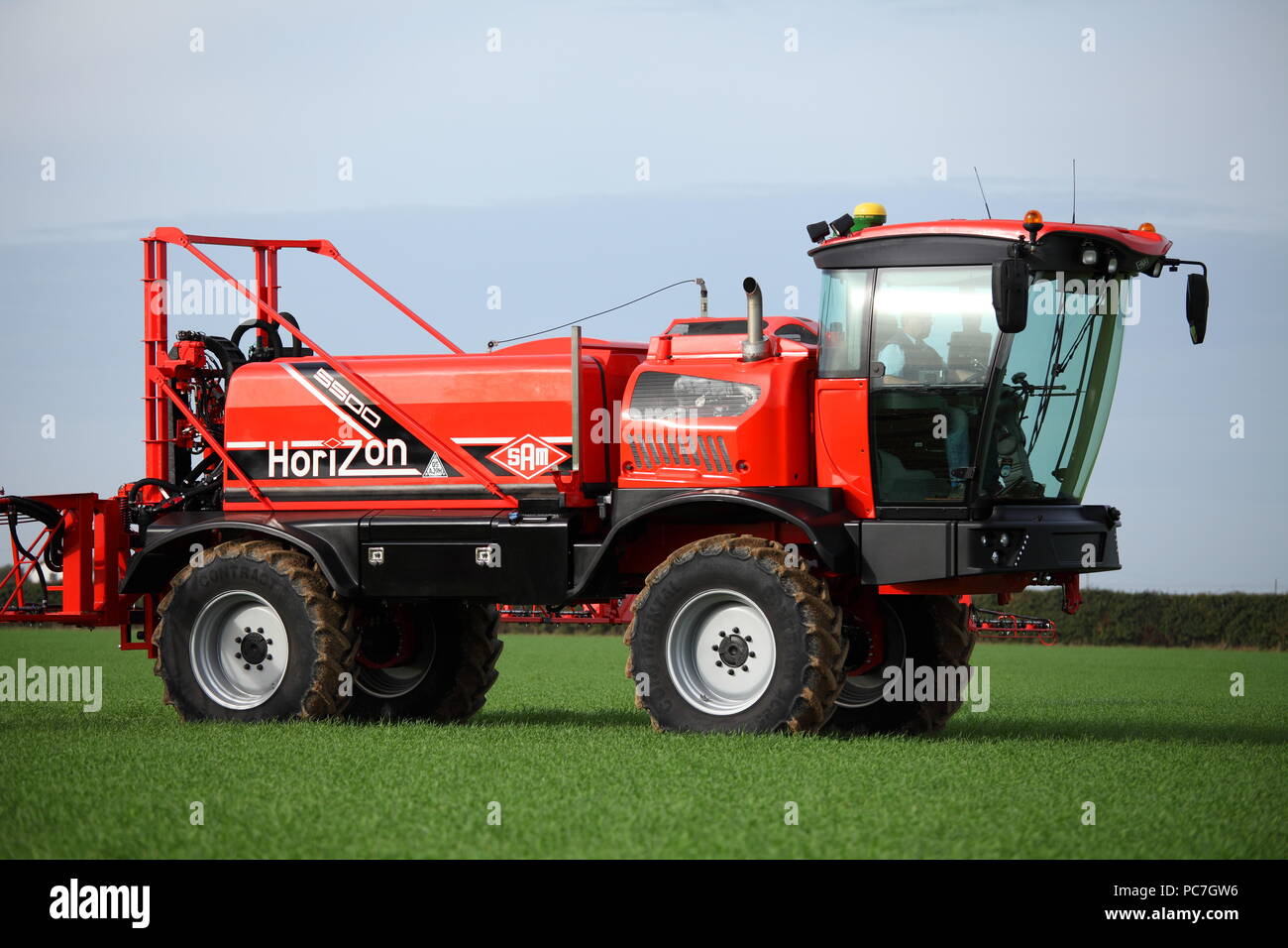A SAM - Sands Agricultural Machinery -  self propelled crop sprayer. Seen here applying fertiliser / fertilizer to a young crop in the UK. Stock Photo