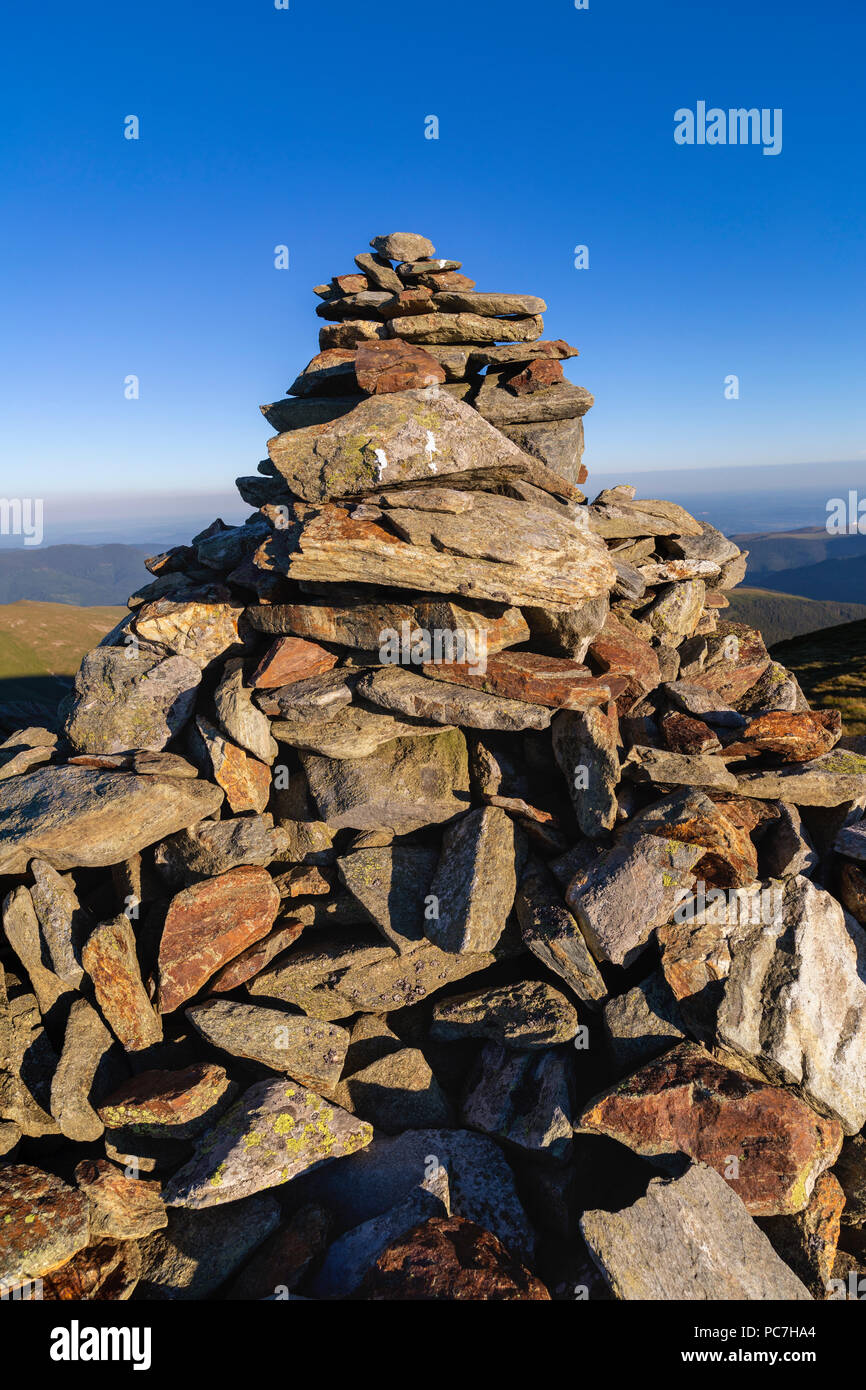 A pile of rocks arranged to mark the top of a mountain Stock Photo - Alamy