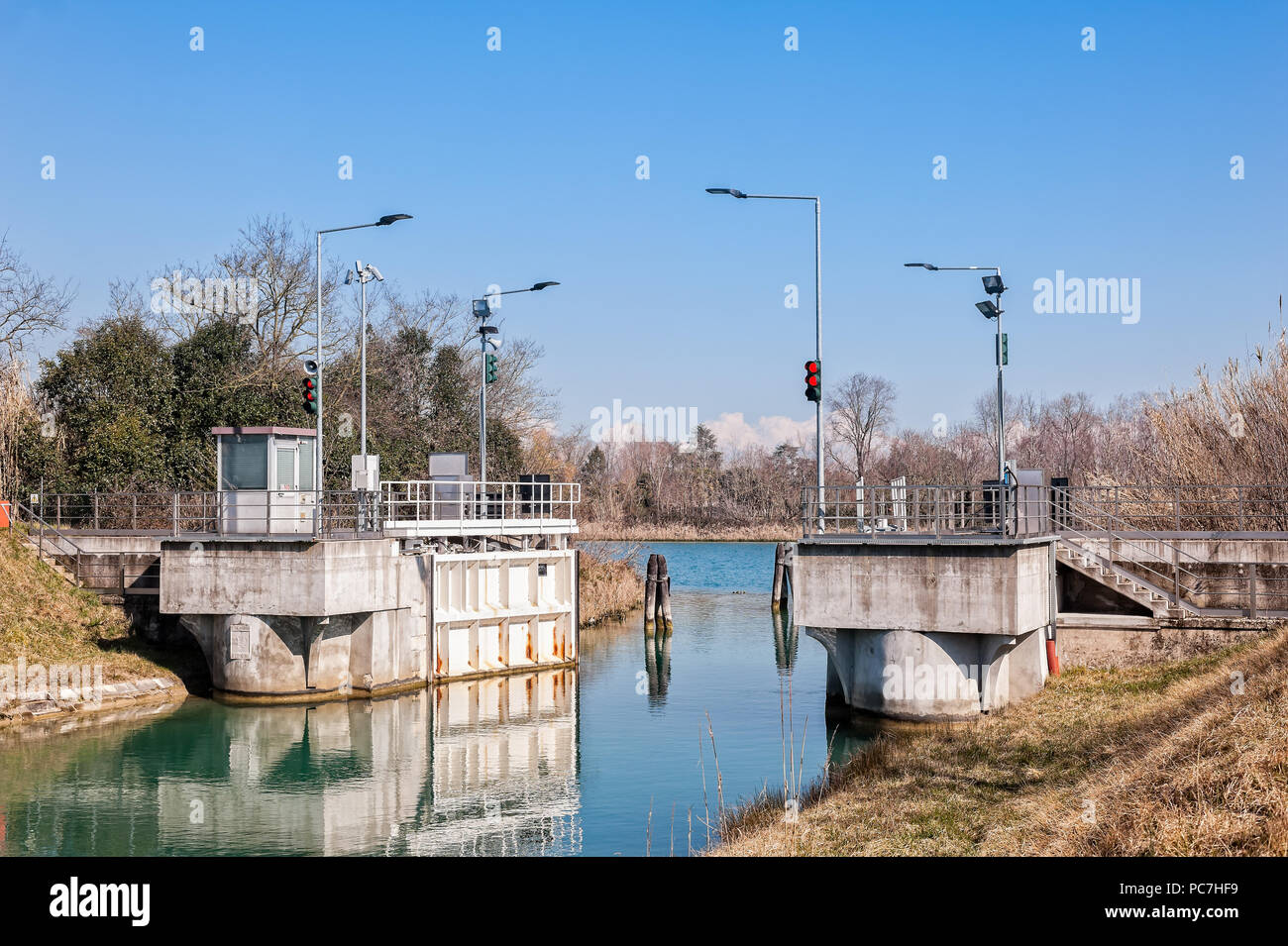 Canal lock and traffic light for regulation of boat traffic. Stock Photo