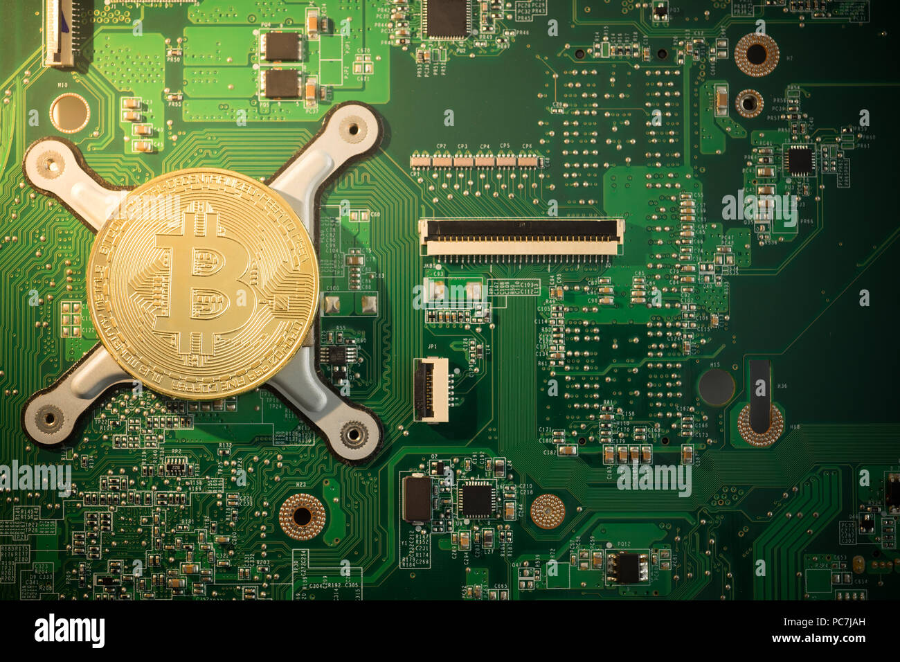 Golden Bitcoin Cryptocurrency gold coin on computer circuit board Stock ...