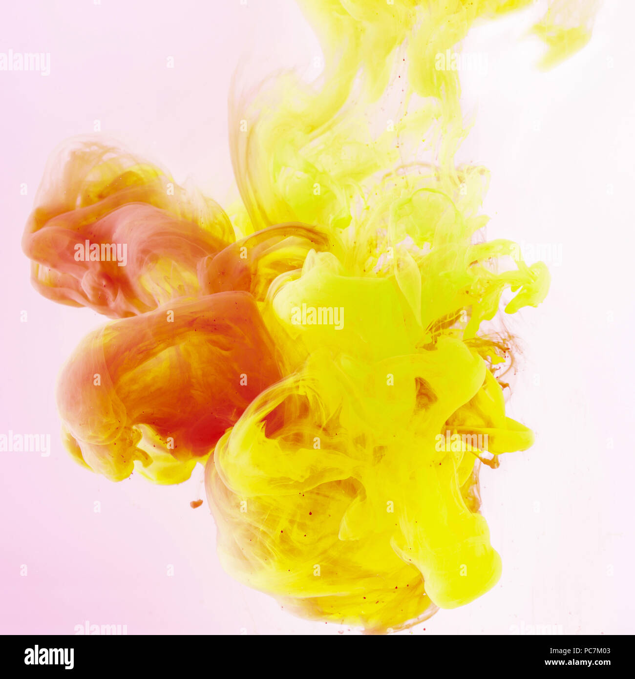 artistic background with flowing yellow and red paint on pink Stock ...