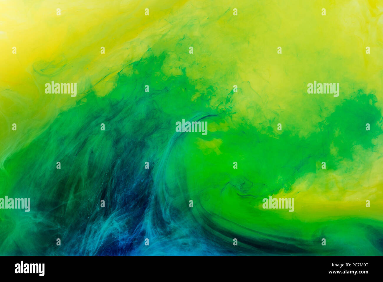 abstract background with green paint flowing in yellow water Stock ...