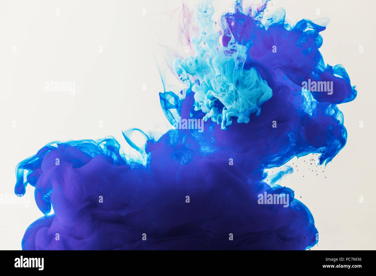 background with flowing blue and turquoise paint in water, isolated on ...