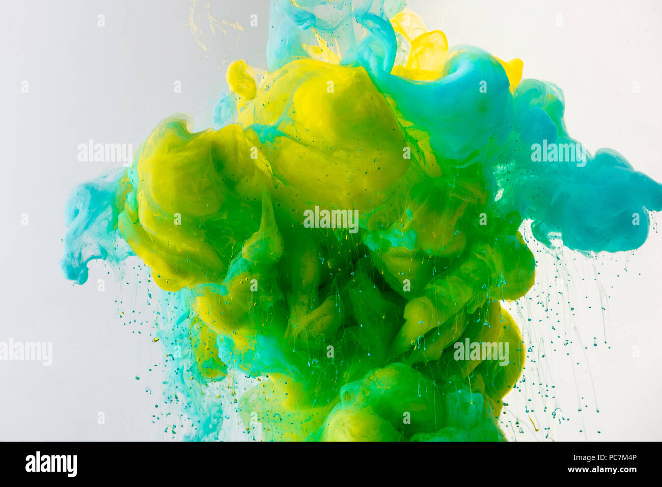 artistic background with flowing turquoise, yellow and green paint in ...