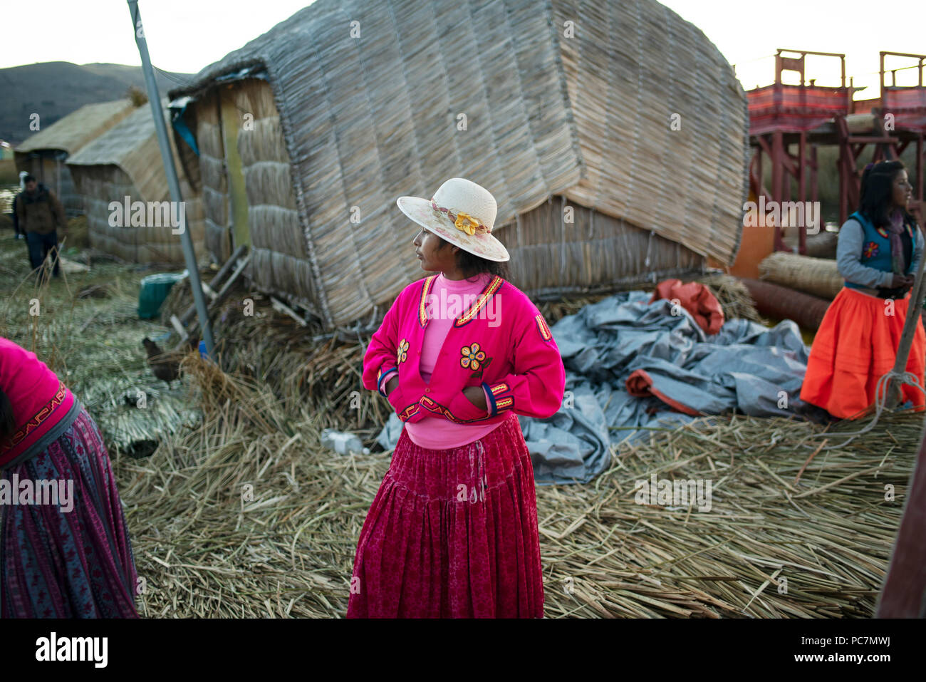 Uru (Uros) native woman in layered skirt and derby-style straw hat. If they wear a red skirt, it means they are married. Islas Flotantes, Peru. Ju2018 Stock Photo