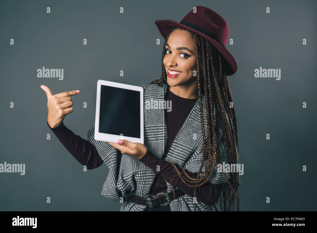 happy african american girl holding digital tablet and pointing at ...