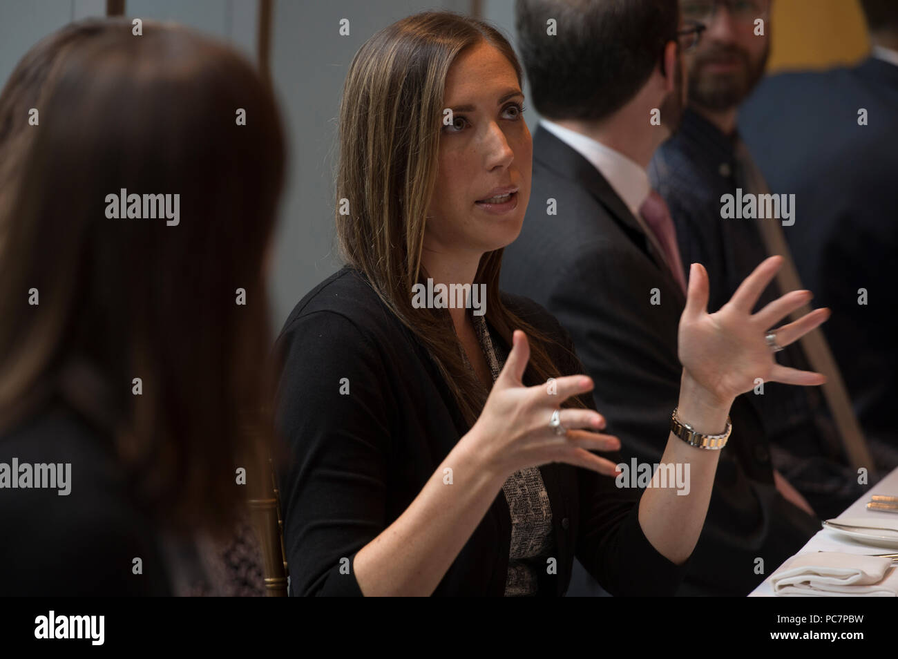 UNITED STATES: July 31, 2018: Sam Krall (back to camera) and Laura Golden Liff talk during the next Gen luncheon at the 2941 Restaurant in Arlington V Stock Photo