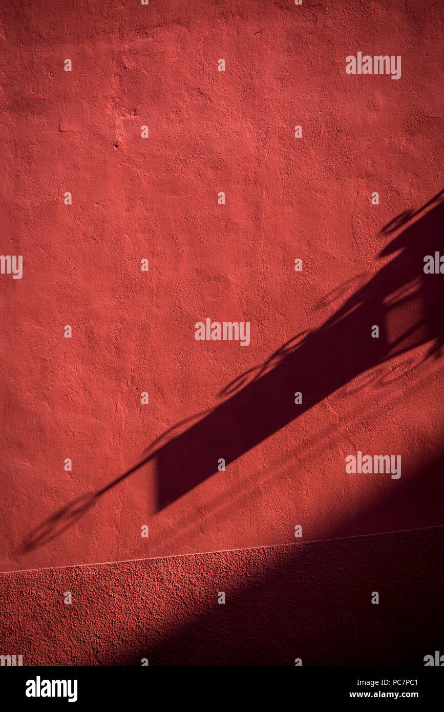 San Miguel de Allende, Shadow of a shop sign on red wall in a colonial-era city,  Bajío region, Central Mexico Stock Photo
