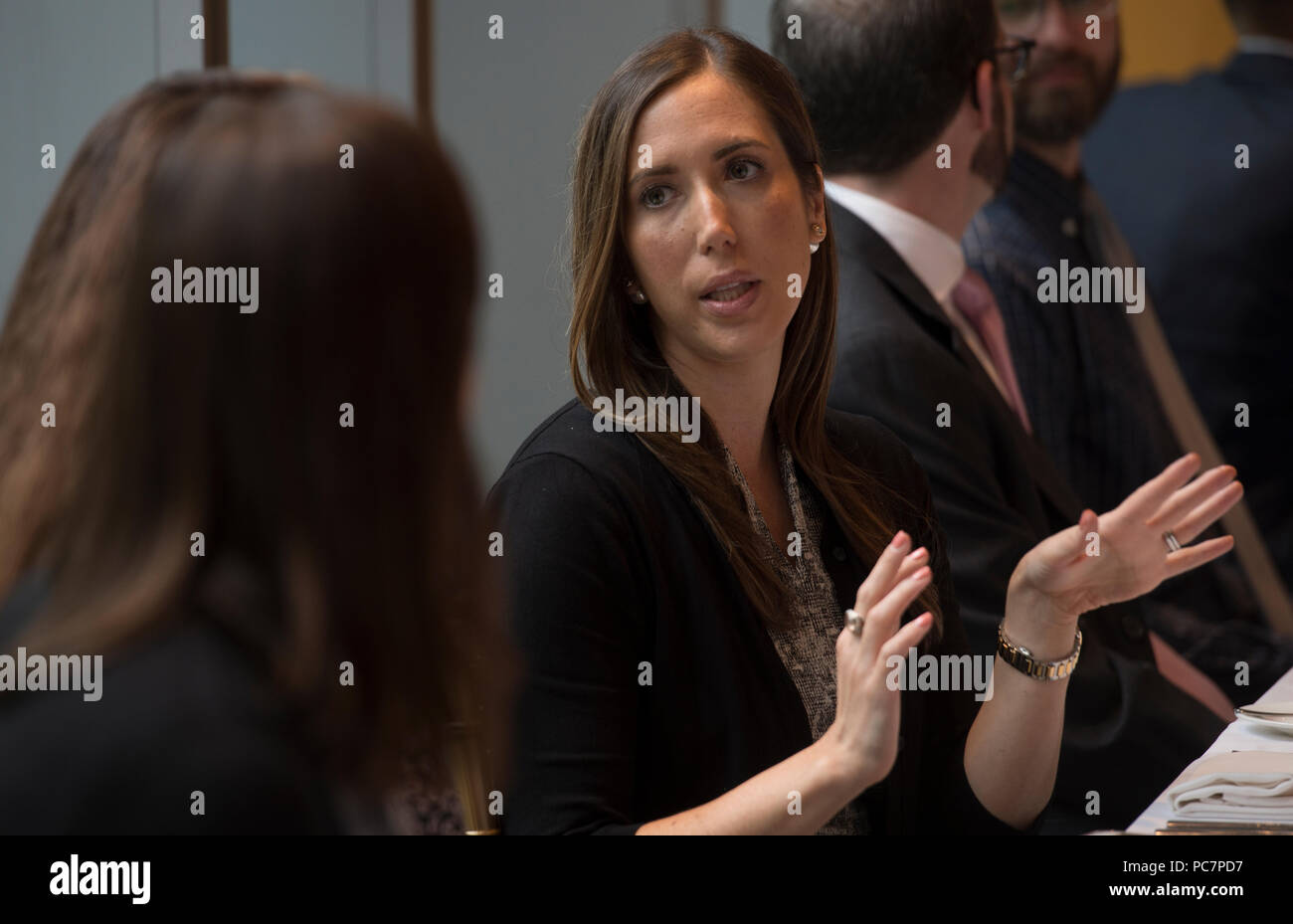 UNITED STATES: July 31, 2018: Sam Krall (back to camera) and Laura Golden Liff talk during the next Gen luncheon at the 2941 Restaurant in Arlington V Stock Photo